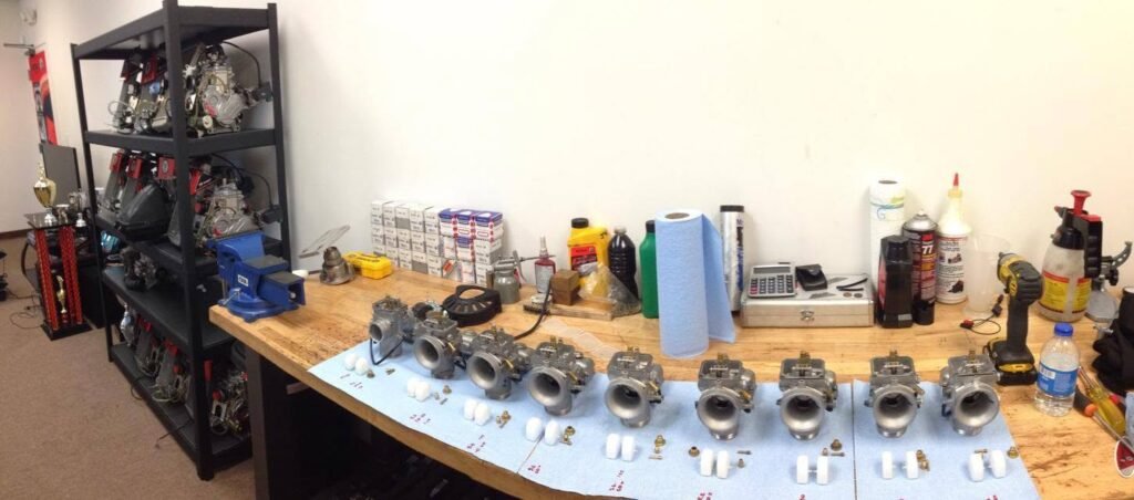 Engine cylinders and parts laid out on the shop workbench