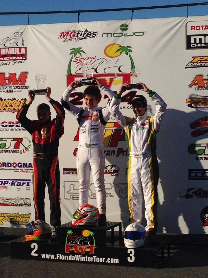 Three drivers lifting trophies on the Florida Winter Tour 2014 podium