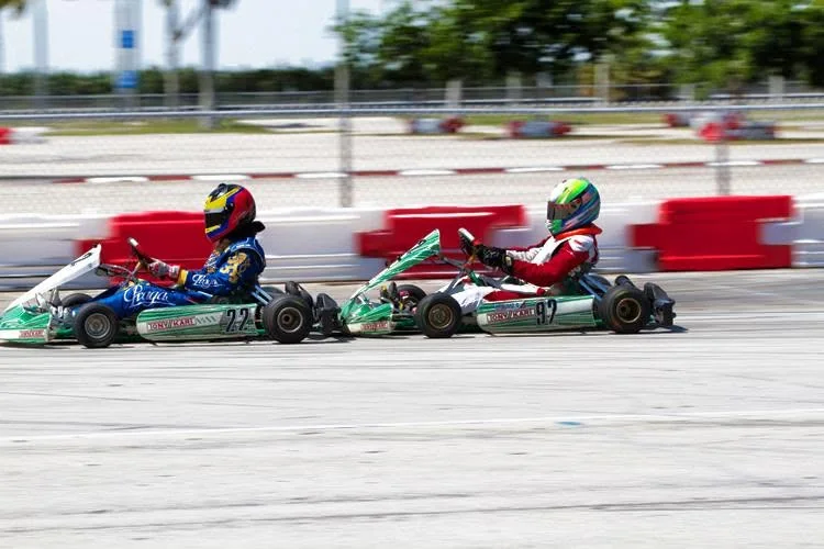 Two race karts running side by side on track